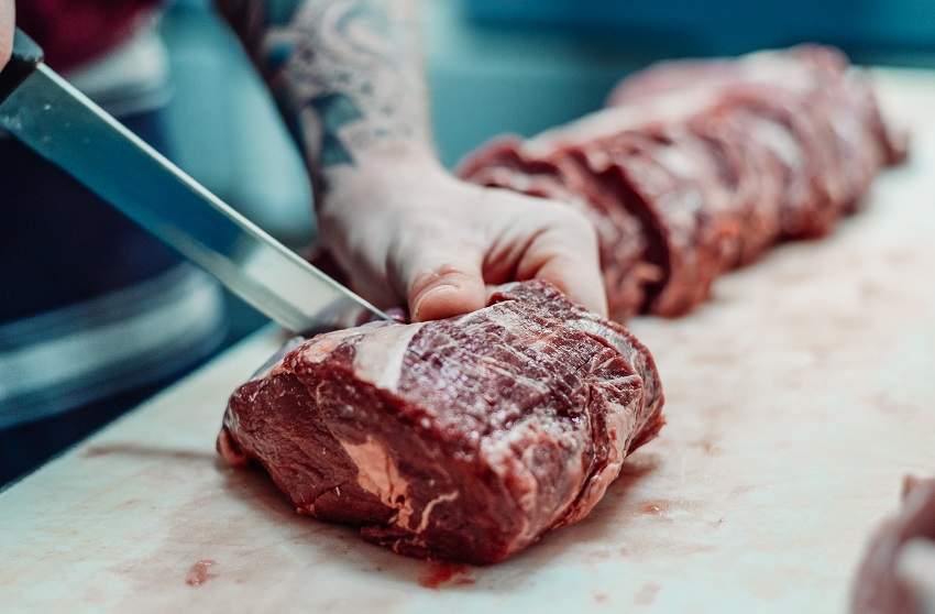 Butcher cutting angus beef